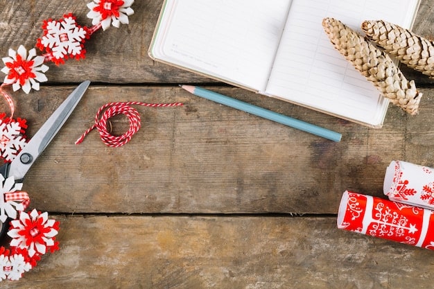 A close-up shot of a writer's desk with a notebook, pen, and several craft books like 