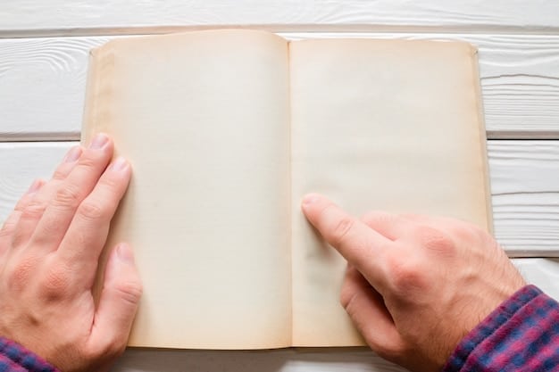 A close-up shot of a person's hands holding an open book. The book is old, with slightly yellowed pages and worn edges. The hands are gently turning a page, and there's a sense of reverence and care in the way they handle the book. The background is blurred, focusing attention on the book and the hands.