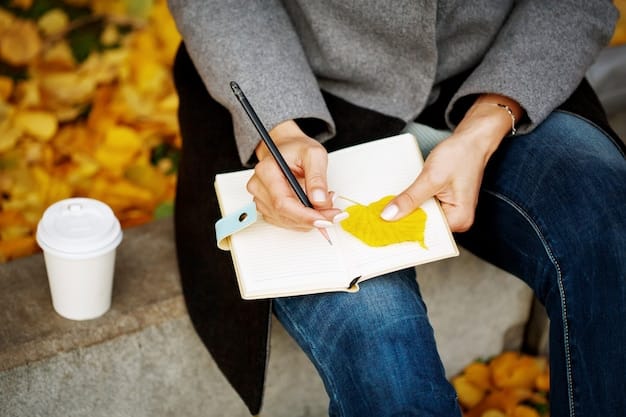 A hand holding a pen signing a book at a book launch event, with blurred people in the background.