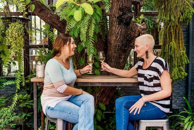 Two people sitting at a cafe table, deeply engaged in conversation. One is gesturing animatedly while the other listens intently. The scene captures the natural ebb and flow of a real-life dialogue.