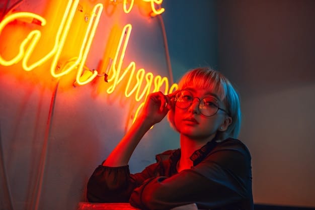 An author is smiling, hand on chin. She stands in front of neon letters spelling “Creativity,” hinting that humans are essential even with AI