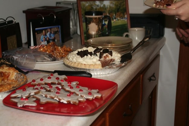 A photograph of an empty dining room table, set for a meal but with no one present. This symbolizes the absence and breakdown of family connection.
