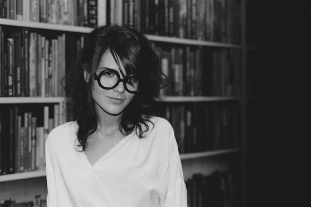 A black and white portrait of Michiko Kakutani, showcasing a serious and thoughtful expression. She is wearing glasses and a professional outfit, with bookshelves blurred in the background.