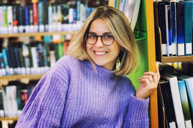 A headshot of Maureen Corrigan, smiling warmly and wearing glasses. She has a friendly and approachable demeanor, with a bookshelf visible in the background.