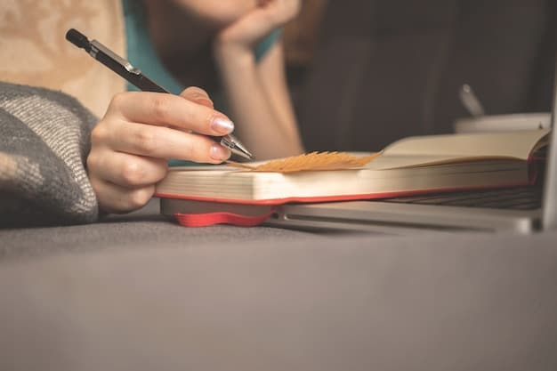 A close-up shot of a hand writing notes on a physical book with a pen, surrounded by more books, emphasizing the traditional method of book reviewing.