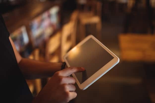 A close-up shot of a person's hand scrolling through book reviews on a tablet, with a blurred background of a bustling bookstore. The focus is on the screen displaying positive ratings and comments.