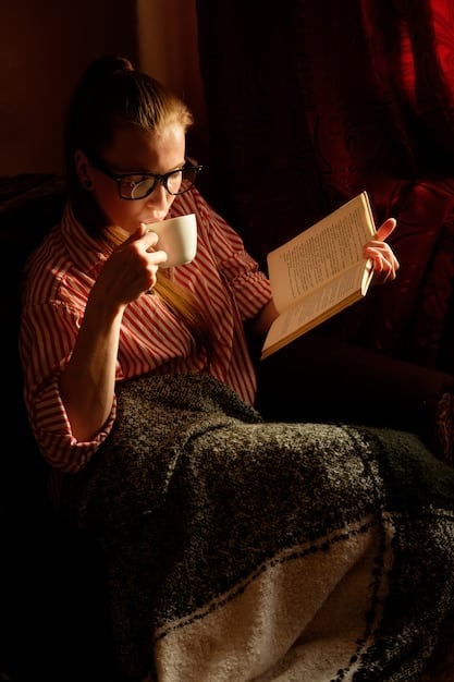 A person sitting in a comfortable chair with a cup of coffee, highlighting passages in a book with a yellow marker. The scene exudes a sense of focused reading and intellectual engagement.