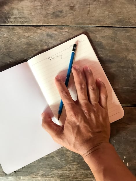 A close-up shot of a hand holding a pen, writing on a notepad filled with notes and ideas related to a book. The backdrop is deliberately blurred, focusing attention on the hand and the act of writing a thoughtful book review, highlighting aspects of book reviewing as a side hustle.