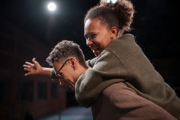 A close-up shot of two actors performing an emotionally charged scene on stage. The lighting is dramatic, highlighting their facial expressions and gestures. The scene conveys a sense of tension and conflict, illustrating the power of acting. This visually depicts the importance of skilled acting.
