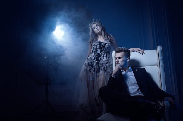 Wide shot of an immersive theater performance set in a dimly lit, gothic-style mansion. Actors in period costumes interact with audience members who are free to roam and explore the space. The setting is detailed and atmospheric, enhanced by theatrical lighting and sound effects, creating a sense of mystery and intrigue. Relates to: Is Immersive Theater the Future? Exploring the Latest Trends in Audience Engagement.