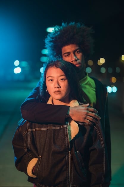 A close-up shot of two actors, one Black and one Asian, in a tense scene from a play. The lighting is dramatic, highlighting their expressions of conflict and determination. This image powerfully illustrates The Importance of Diversity in Theater: A Look at Representation On and Off Stage.