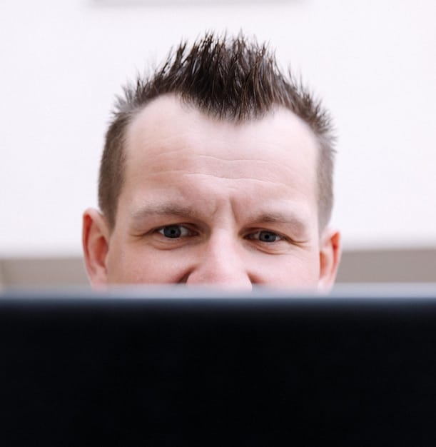 A close-up of a person's eyes, slightly strained, with a reflection of a screen in the pupils. This image highlights the importance of eye care during 'Binge-Watching Like a Pro: Tips and Tricks for the Ultimate Streaming Experience'.